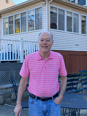 Bill Pegram standing outside rear of house